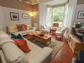 A living room with a sofa and coffee table at 1 Park Road Windermere