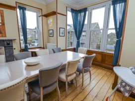 A dining room with a table and chairs at 1 Park Road Windermere