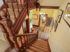 A staircase and hallway with patterned flooring at 1 Park Road Windermere