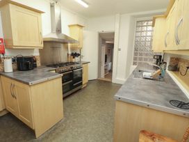 A kitchen with cabinets, oven, stove, and sink at 1 Park Road Windermere