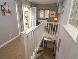 A staircase landing with a door and window at 1 Park Road in Windermere