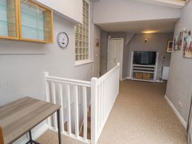 A hallway with a table and television at 1 Park Road in Windermere