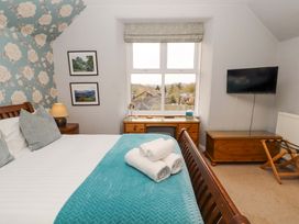 A bedroom with a window and television at 1 Park Road in Windermere