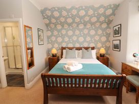 A bedroom with a bed and a shower at 1 Park Road Windermere