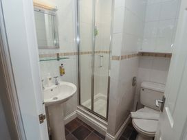A bathroom with a shower, sink, and toilet at 1 Park Road in Windermere