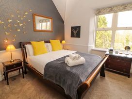A bedroom with a bed and dresser at 1 Park Road Windermere
