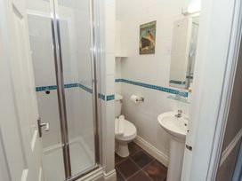 A bathroom featuring a shower, toilet, and sink at 1 Park Road in Windermere