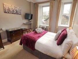 A bedroom with a bed and television at 1 Park Road in Windermere