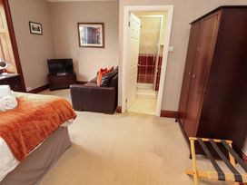 A bedroom with a bed and a television at 1 Park Road in Windermere