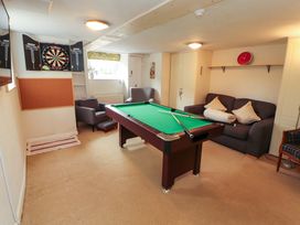 A games room with a pool table and dartboard at 1 Park Road in Windermere