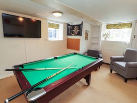 A recreation room with a pool table and television at 1 Park Road Windermere