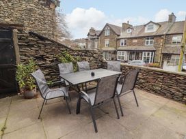 An outdoor seating area with a table and chairs at 1 Park Road Windermere