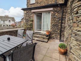 An outdoor area with a table and chairs at 1 Park Road in Windermere