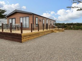 A house with a deck and chairs at Dolphin in Haverfordwest