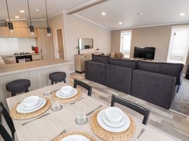 A living room and dining area with a kitchen at Dolphin in Haverfordwest