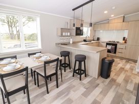 A kitchen with a dining area and bar stools at Dolphin in Haverfordwest