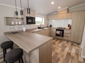 A kitchen with countertops and stools at Dolphin in Haverfordwest