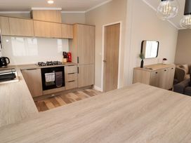 A kitchen with cabinets and appliances at Dolphin in Haverfordwest