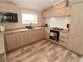 A kitchen with cabinets and appliances at Dolphin in Haverfordwest