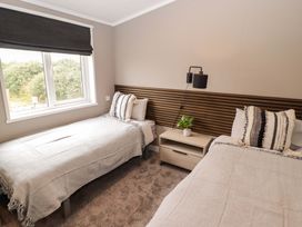 A bedroom with two beds and a nightstand at Dolphin in Haverfordwest