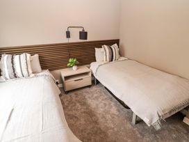 A bedroom with two beds and a nightstand at Dolphin Haverfordwest