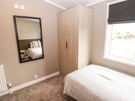 A bedroom with a wardrobe and mirror at Dolphin in Haverfordwest