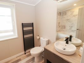 A bathroom with a toilet, sink, and bathtub at Dolphin in Haverfordwest
