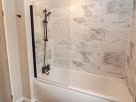 A bathroom with a bathtub and shower at Dolphin in Haverfordwest