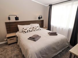 A bedroom with a bed and bedside tables at Dolphin in Haverfordwest