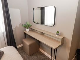 A bedroom with a desk and mirror at Dolphin Haverfordwest