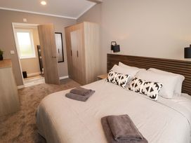 A bedroom with a bed and wardrobe at Dolphin in Haverfordwest