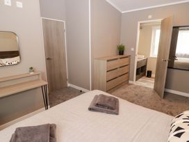 A bedroom with a bed and dresser at Dolphin in Haverfordwest