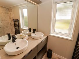 A bathroom with a double sink and mirror at Dolphin in Haverfordwest