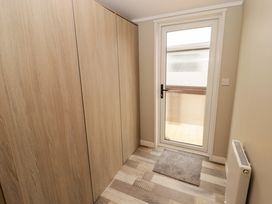 A hallway with a wardrobe and door at Dolphin in Haverfordwest
