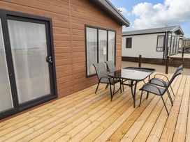 An outdoor seating area with a table and chairs at Dolphin in Haverfordwest