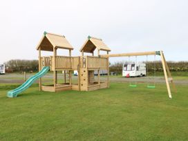 A playground with a slide and swings at Dolphin in Haverfordwest