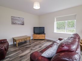 A living room with a television and a coffee table at Teac Caoimhe in Falcarragh