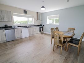 A kitchen with a table and chairs at Teac Caoimhe in Falcarragh