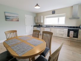 A kitchen with a table and chairs at Teac Caoimhe in Falcarragh