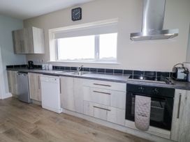 A kitchen with cabinets and appliances at Teac Caoimhe in Falcarragh