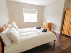 A bedroom with a bed and dresser at Teac Caoimhe in Falcarragh