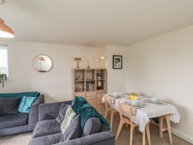 A dining room with a table and chairs at Larpool Retreat 