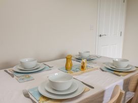 A dining table set with bowls and cutlery at Larpool Retreat