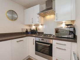 A kitchen with a cooktop and microwave at Larpool Retreat