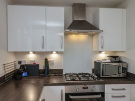 A kitchen with cabinets and cooking appliances at Larpool Retreat