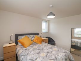 A bedroom with a bed and nightstand at Larpool Retreat