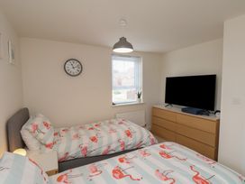 A bedroom with two beds and a television at Larpool Retreat in 