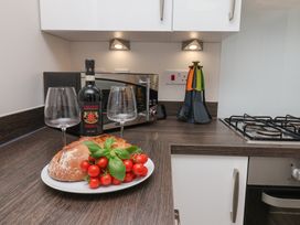 A kitchen with wine glasses, bread, and tomatoes at Larpool Retreat in Whitby