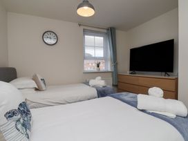A bedroom with two beds and a television at Larpool Retreat in Whitby