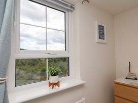 A bedroom with a window and a flower pot at Larpool Retreat in Whitby
